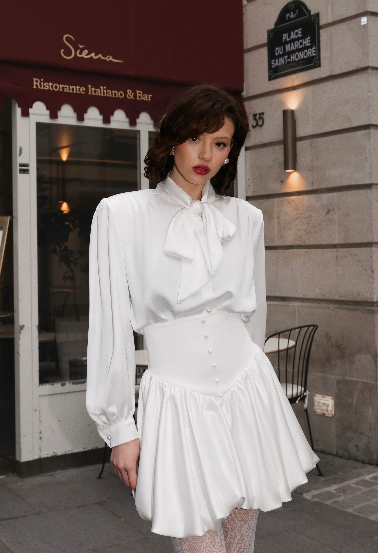 Blouse with accented shoulders and long sleeves with cuffs.