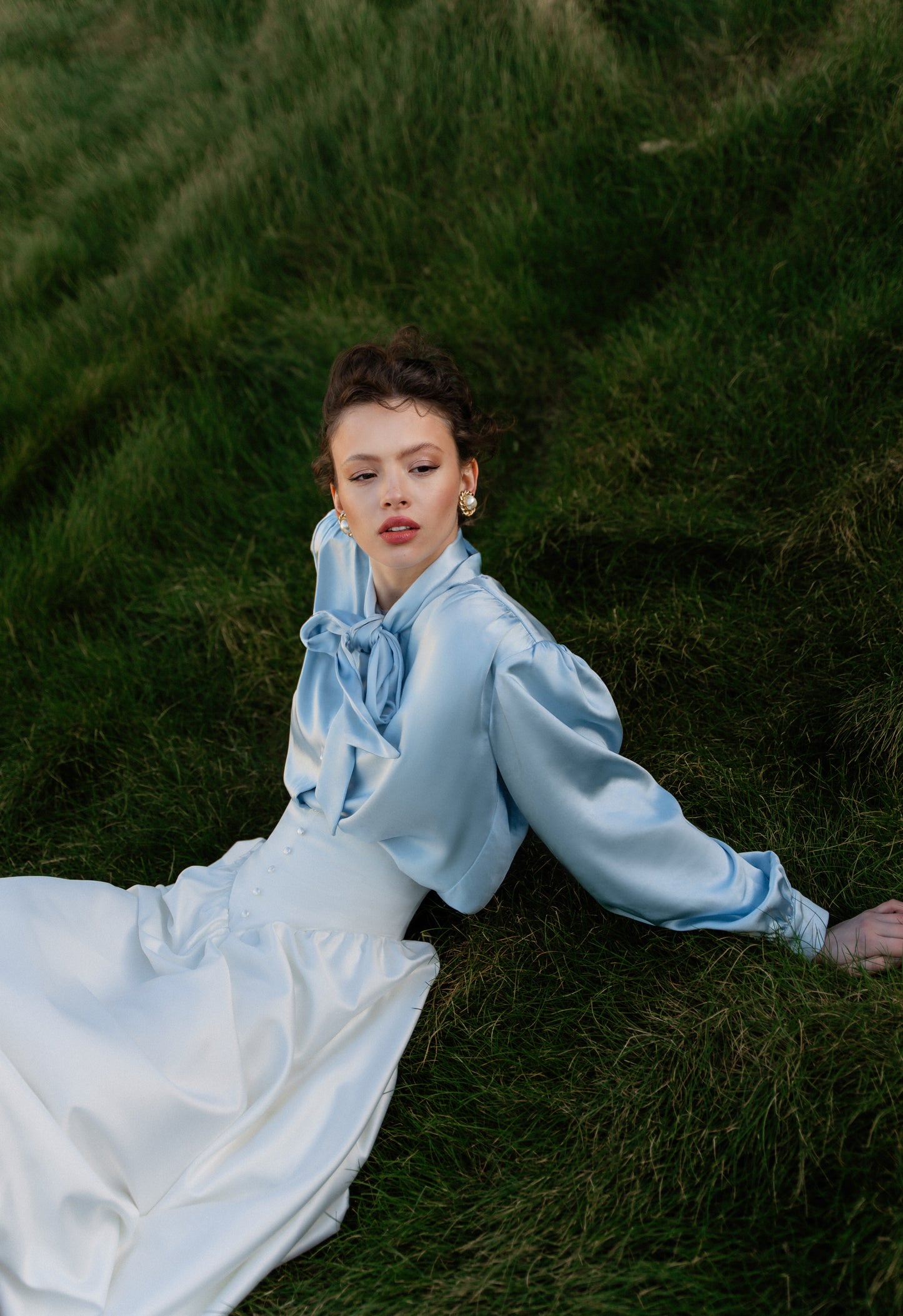 Blouse with accented shoulders and long sleeves with cuffs.